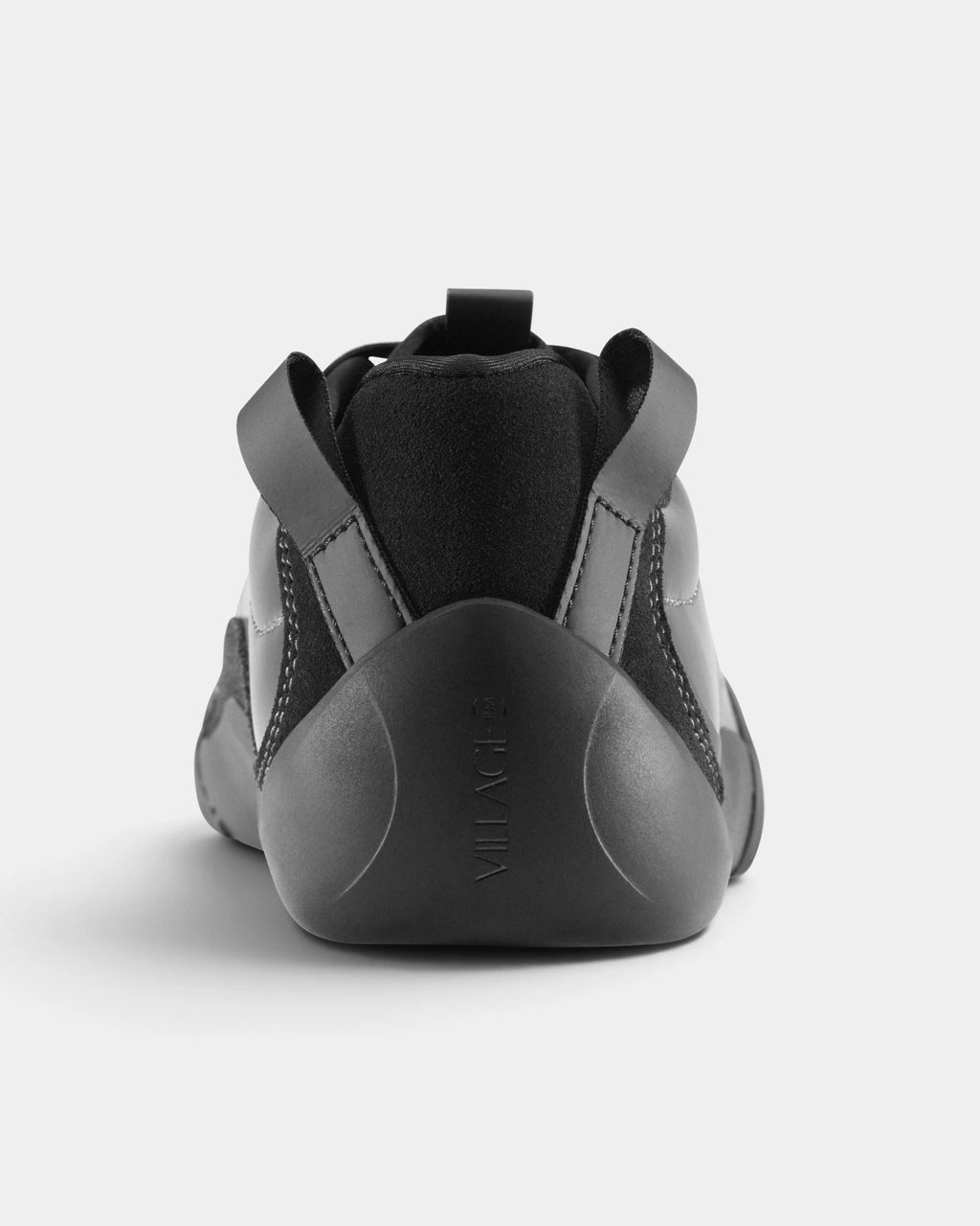 Village PM 2PM Synth Leather Shoes in Anthracite/Natural Black: a single shoe seen straight on from behind, showing the heel counter and collar. A anthracite synthetic leather low-top skate shoe on a natural black gum outsole.