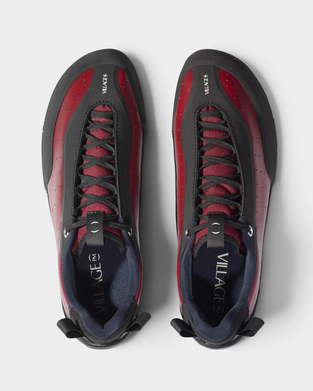 Village PM 2PM Synth Leather Shoes in Red/Natural Black: a red perforated leather low-top skate shoe with black overlays and a black sole, the pair seen from above with the laces and the insoles