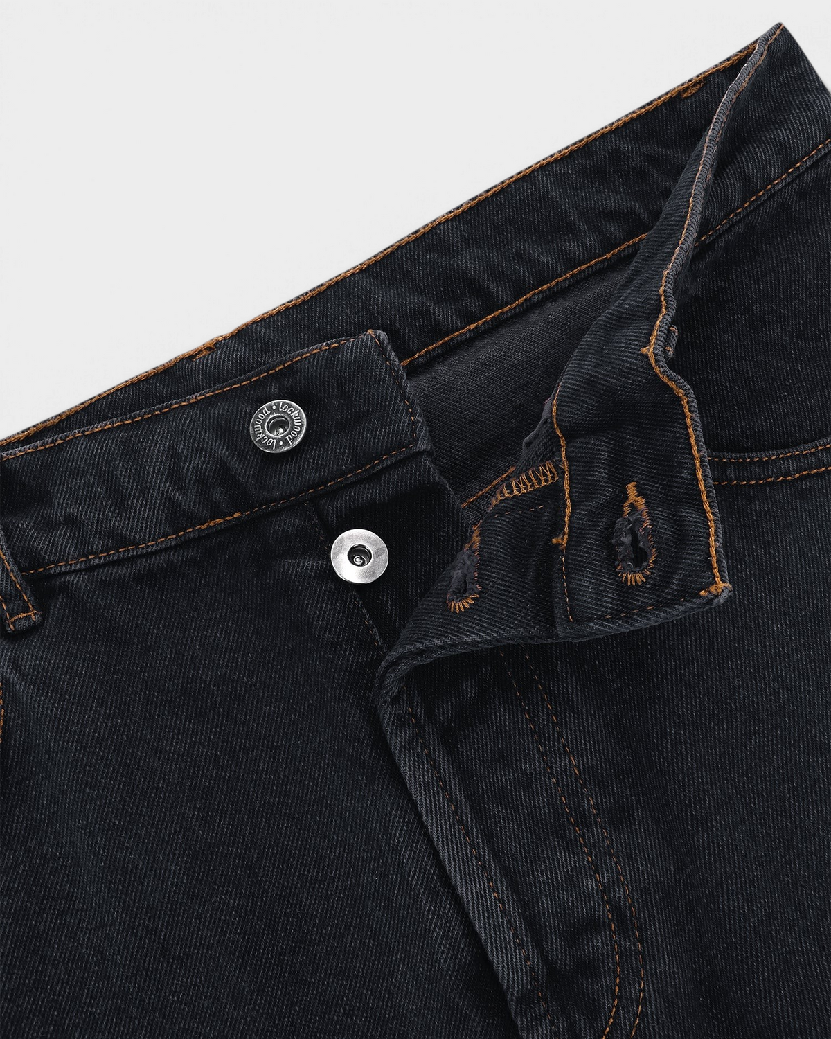 Close-up of the button fly and waistband on the Black Olive Classic Relaxed Jeans